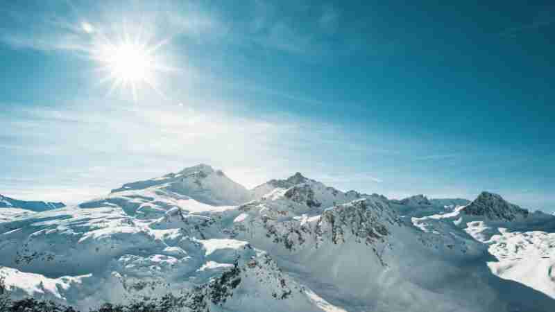 Breathtaking view of snow-covered peaks in Val-d'Isère, France under bright winter sun., tags: hitzewelle und - pexel